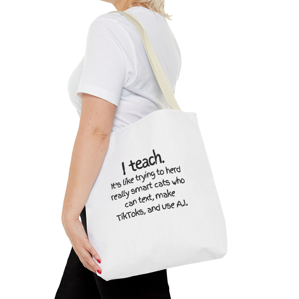 Teacher Tote Bag — “I teach. It’s like trying to herd really smart cats who can text, make TikToks, and use AI.”