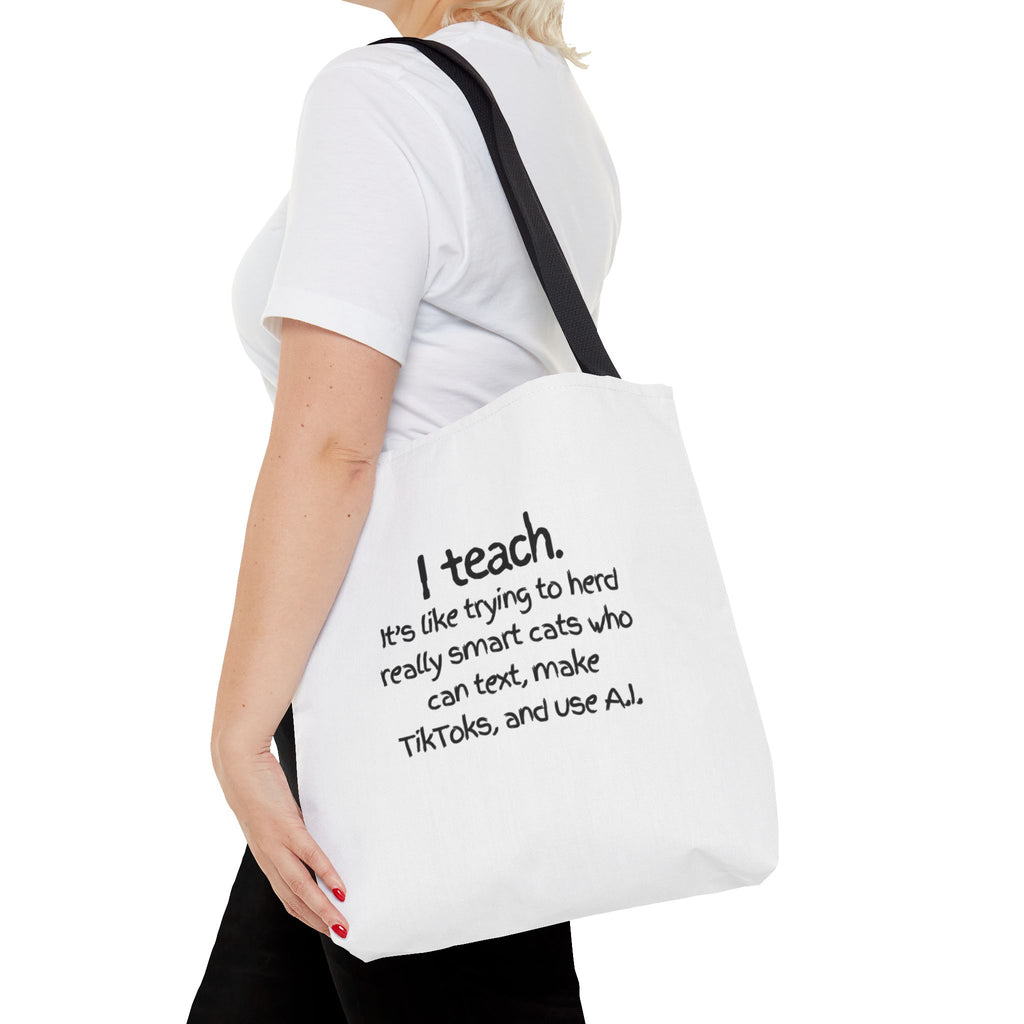 Teacher Tote Bag — “I teach. It’s like trying to herd really smart cats who can text, make TikToks, and use AI.”