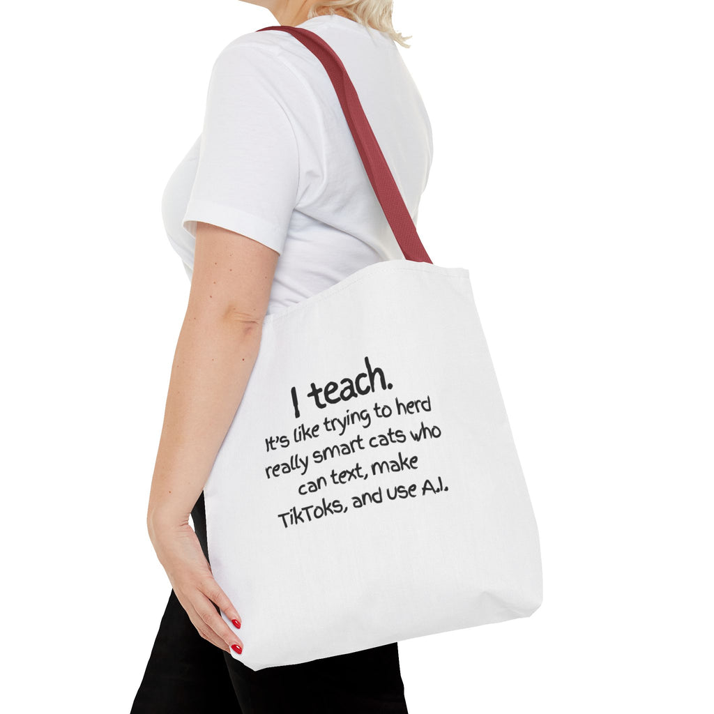 Teacher Tote Bag — “I teach. It’s like trying to herd really smart cats who can text, make TikToks, and use AI.”